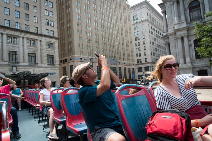 Philadelphia Sightseeing Tours passengers taking pictures of the city on the tour