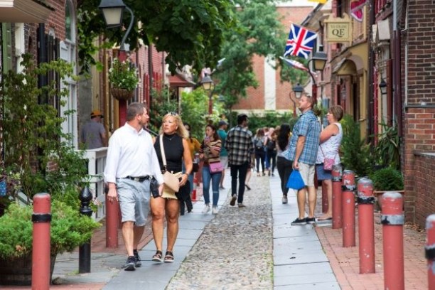 a group of people walking on a sidewalk