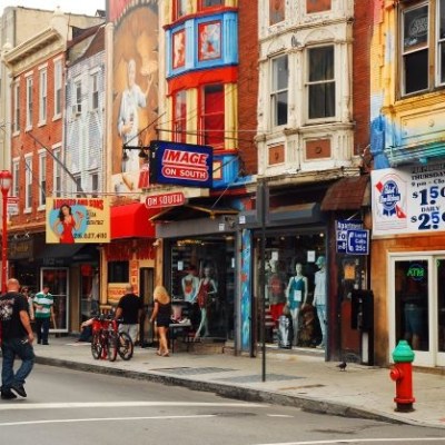a group of people walking on a city street