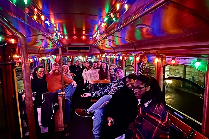 a group of people standing in front of a bus