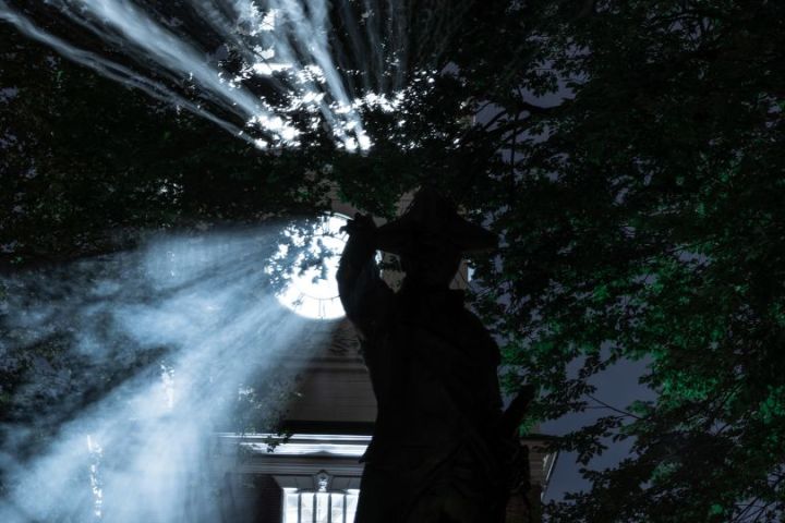 a man standing next to a waterfall