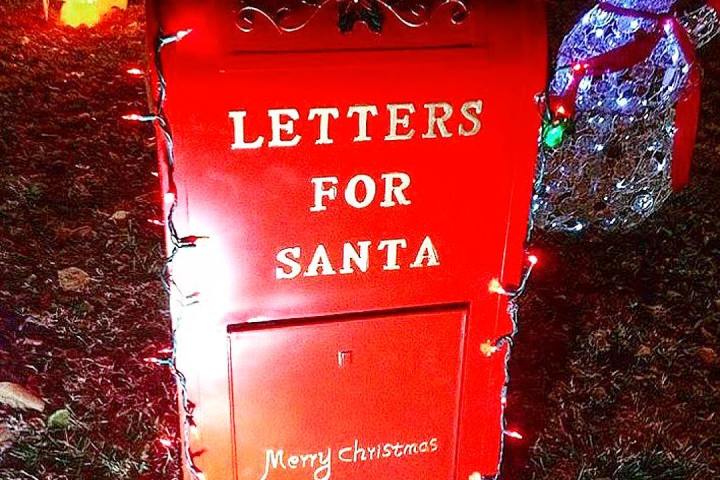 Red mailbox labeled 'Letters for Santa' with holiday lights and a snowman nearby.